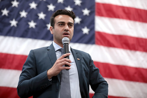 Abe speaking in front of American Flag