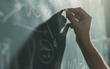 Writing math problem on a chalkboard